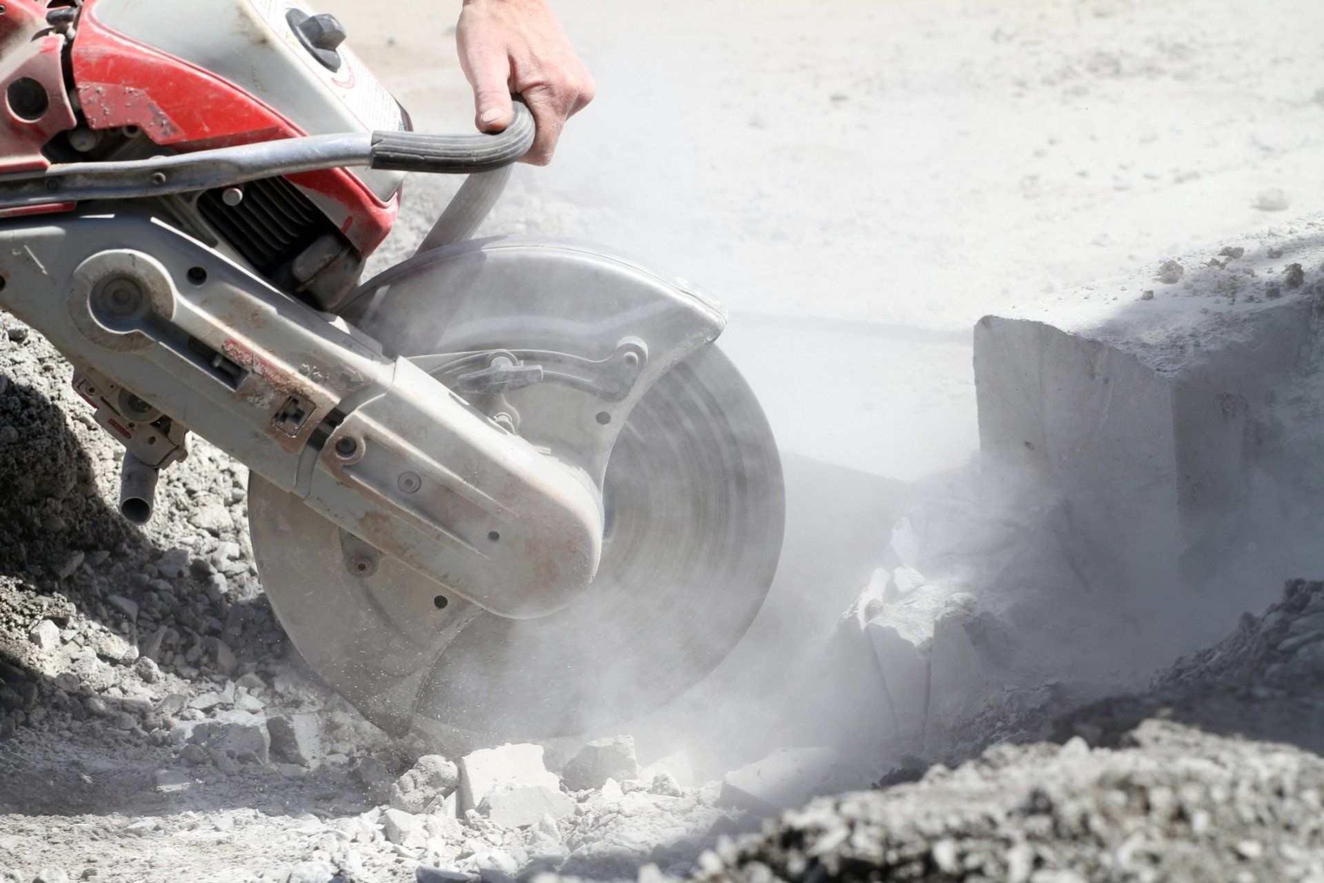 Person Using A Concrete Saw — Watson, LA — Capitol City Concrete Cutters LLC