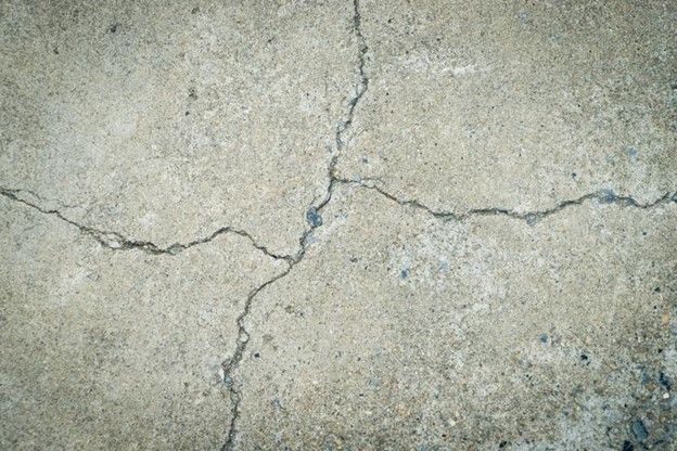 A close up of a cracked concrete floor.