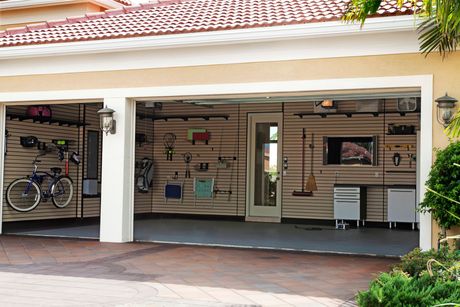 A garage with a bicycle parked in it and a television on the wall.