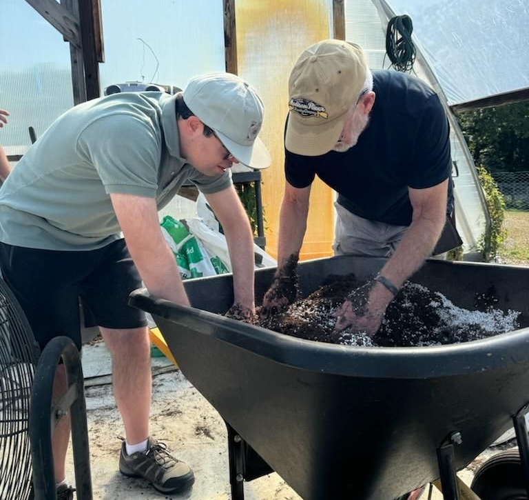 men wheelbarrow and dirt