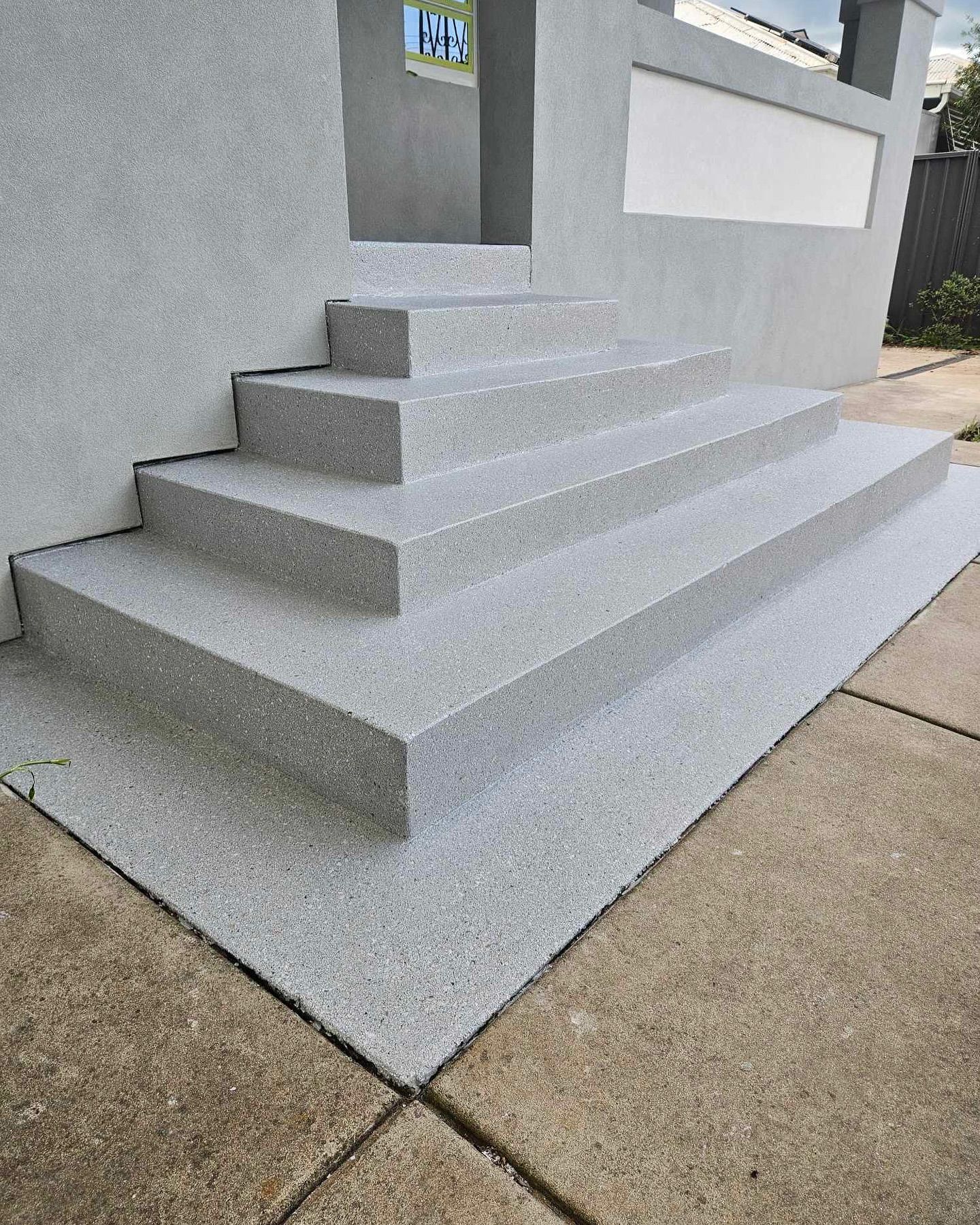 Gray stone steps leading to a building with a white accent wall — Riverina Epoxy Flooring In Glenfield Park, NSW