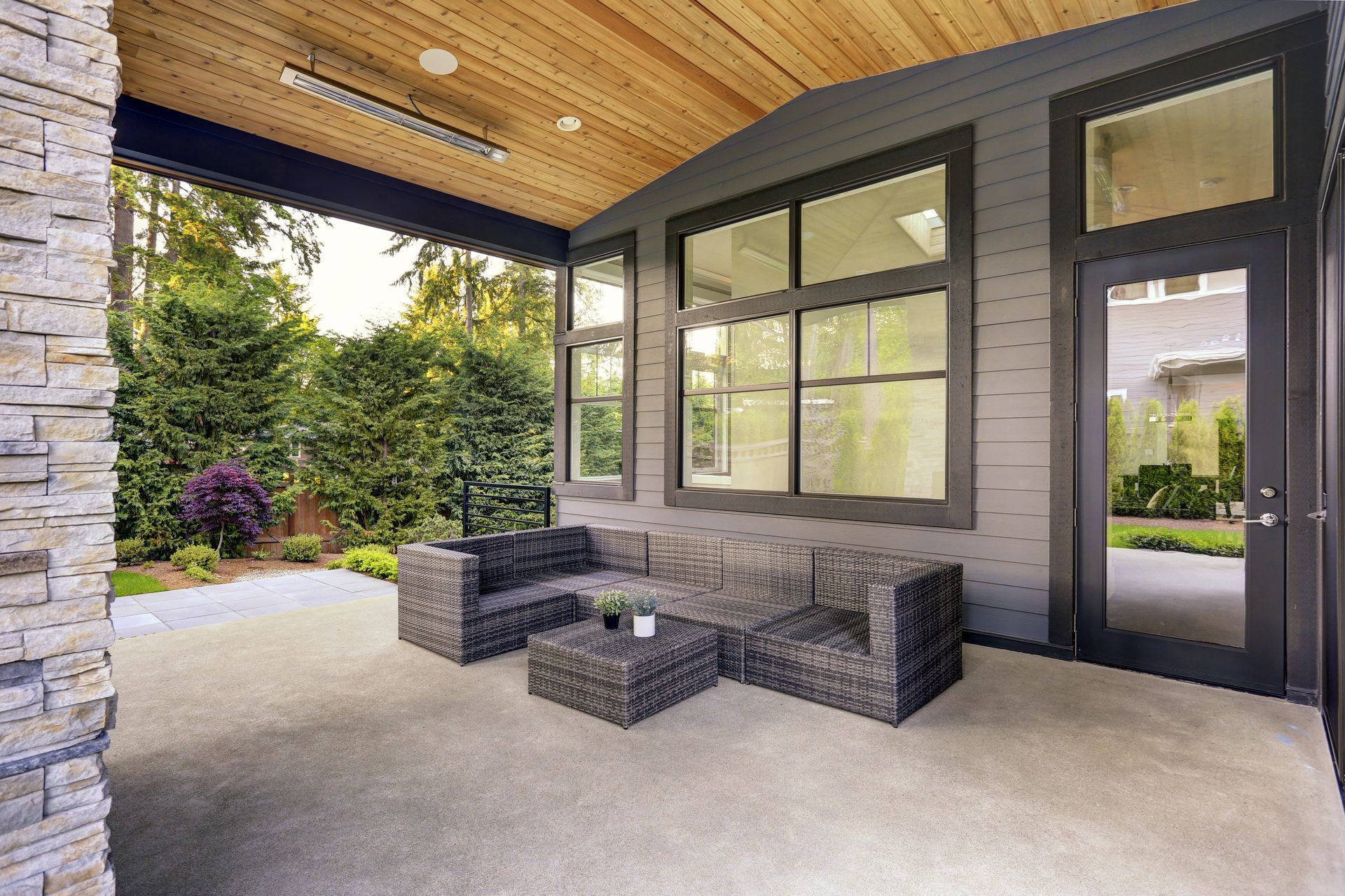 Contemporary home with a backyard showcasing a concrete patio.