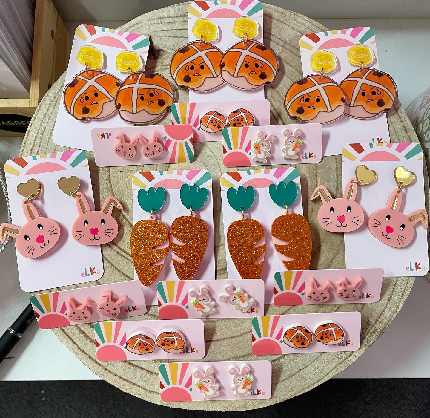 A variety of earrings are displayed on a round table