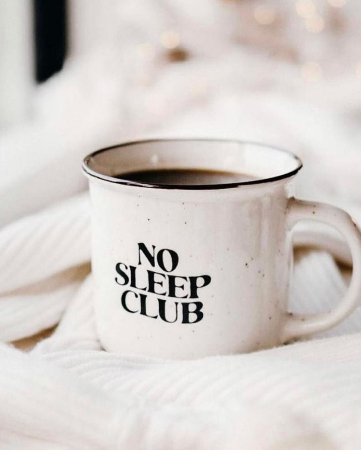 A coffee mug that says no sleep club on it