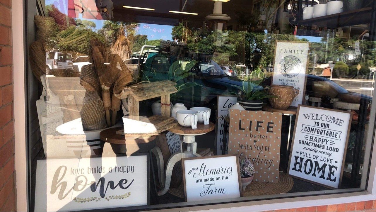 A store window filled with lots of signs and decorations.