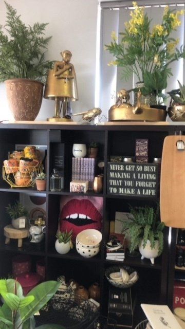 A shelf with a sign that says never get so busy that you forget to make a life