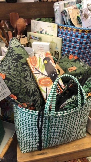 A basket with a bird on it sits on a table