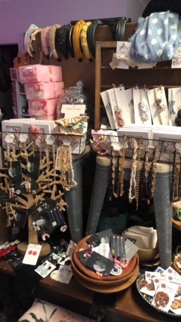 A shelf filled with lots of items including necklaces and headbands