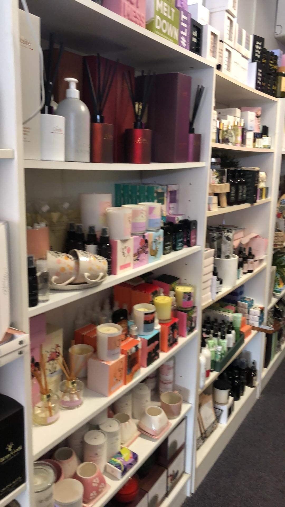 A store filled with lots of shelves filled with candles and other items.