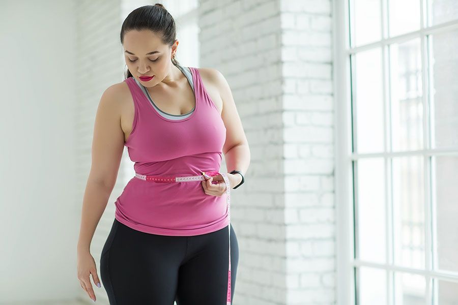 Checking waistline - a sign to visit a weight loss clinic in Singapore - Absolute Wellness