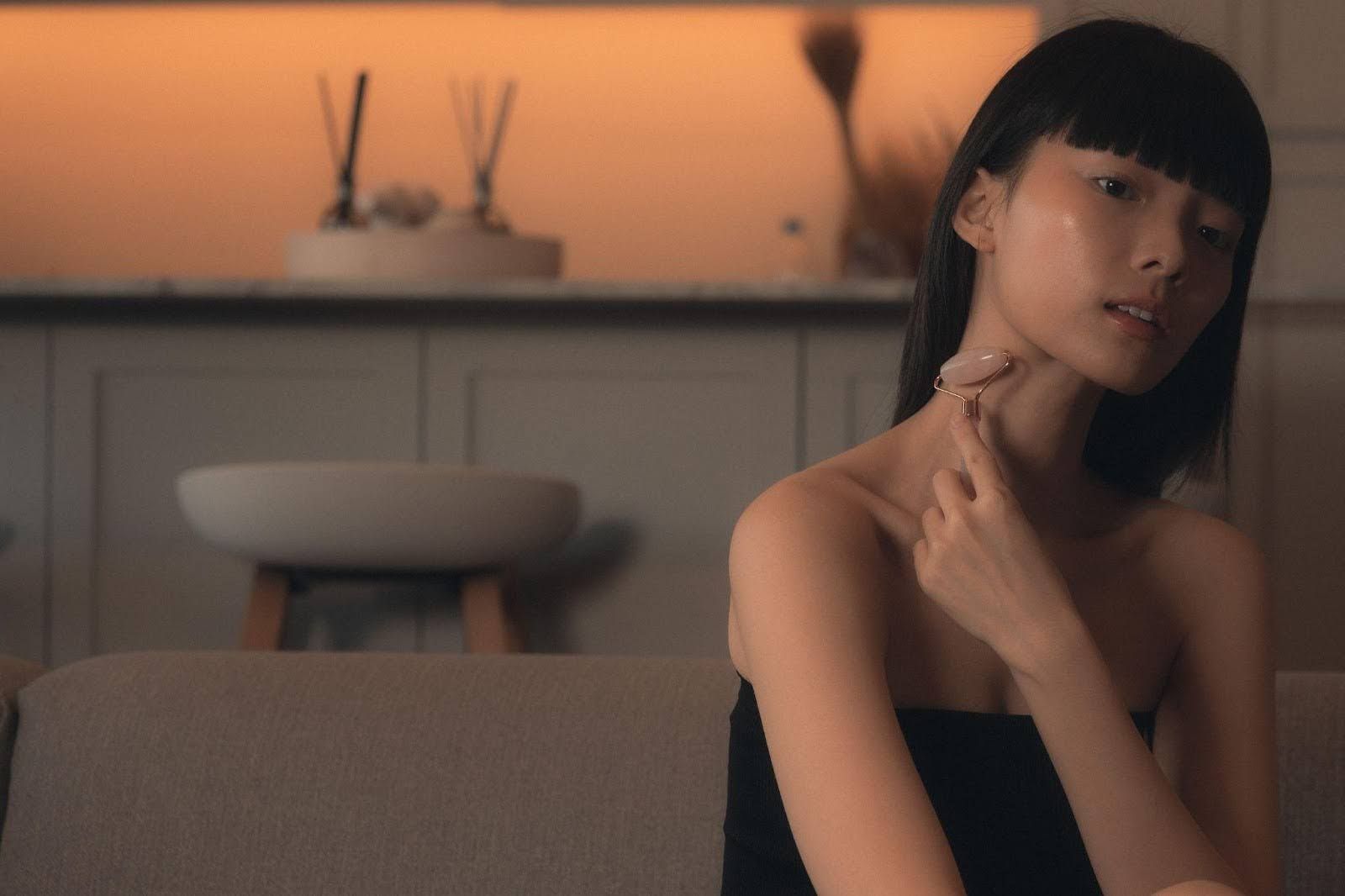 Woman using a Gua Sha roller for Gua Sha Massage in Singapore