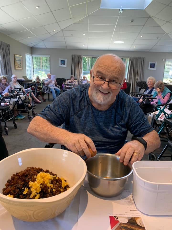 A man is sitting at a table with a bowl of food.