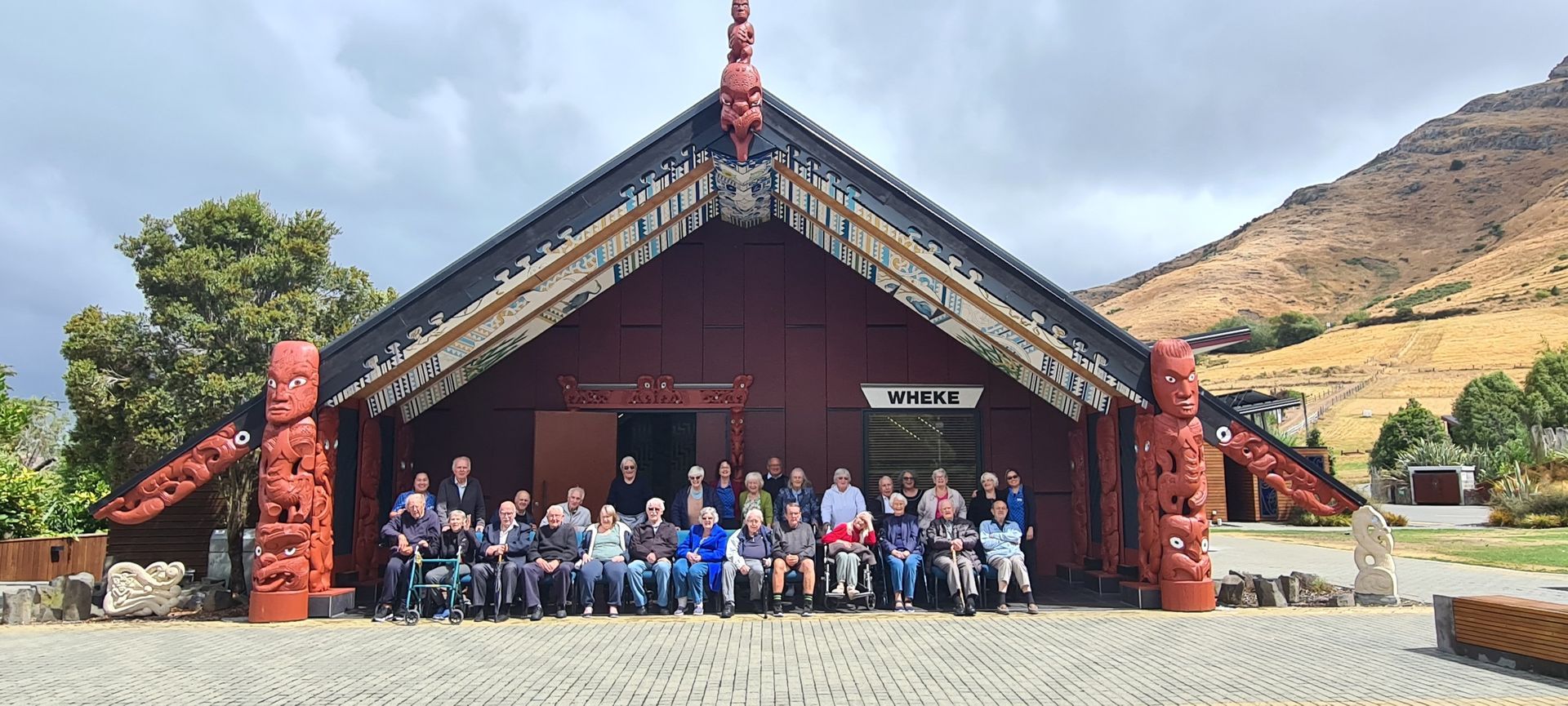 A group of people are posing for a picture in front of a building.
