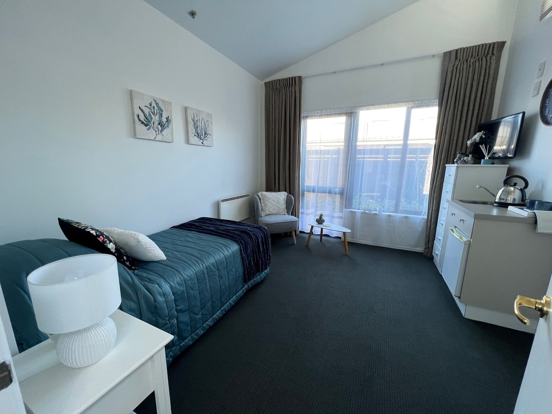 There is a single bed in the middle of the room.