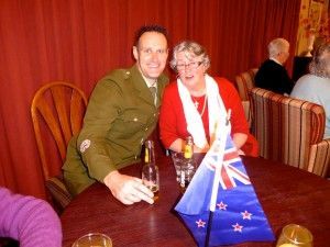 A man in a military uniform sits at a table with a woman