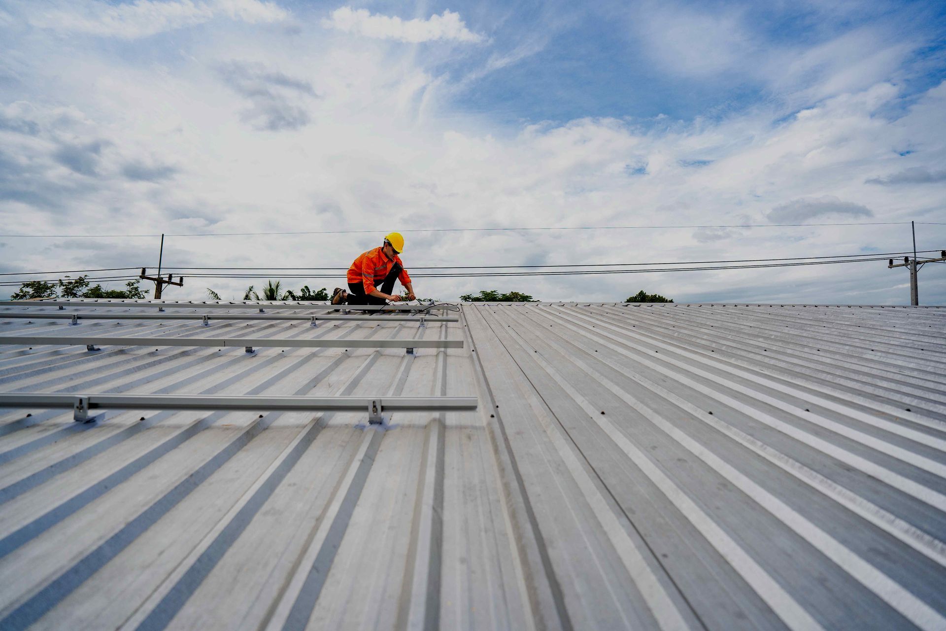 A man is working on the roof of a building.