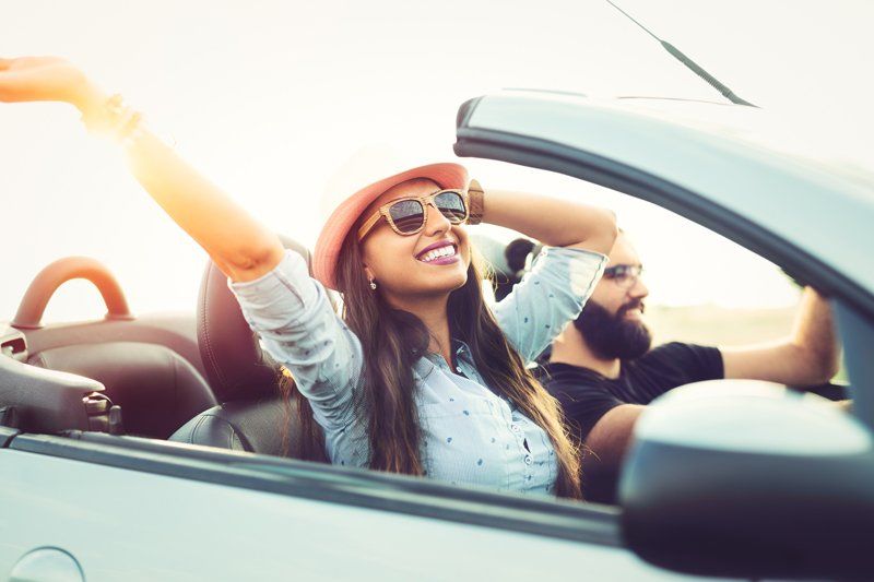 General Liability — Couple Riding a Car Happily in Decatur, GA