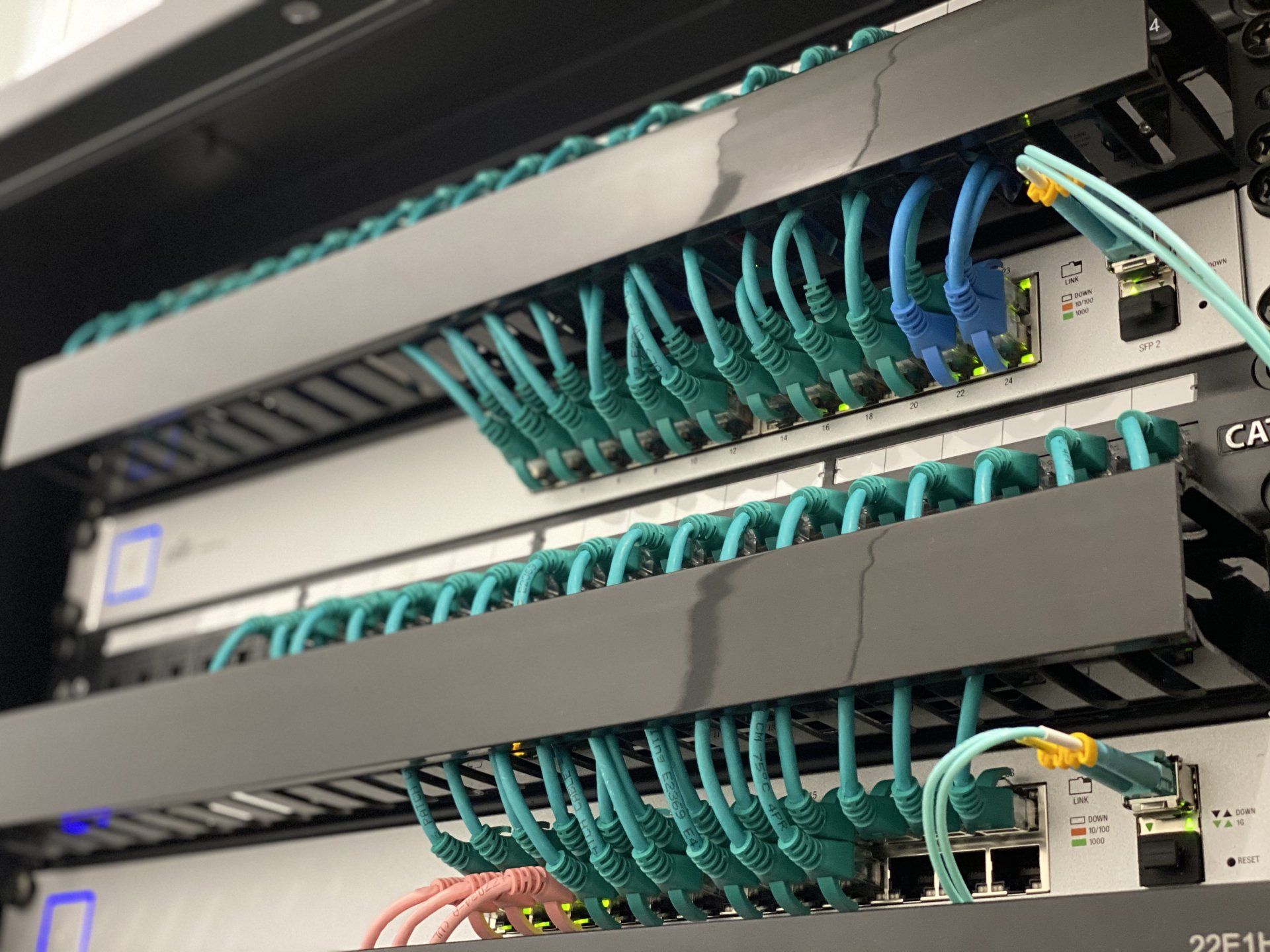 A server rack with patch panels and data cables terminated inside