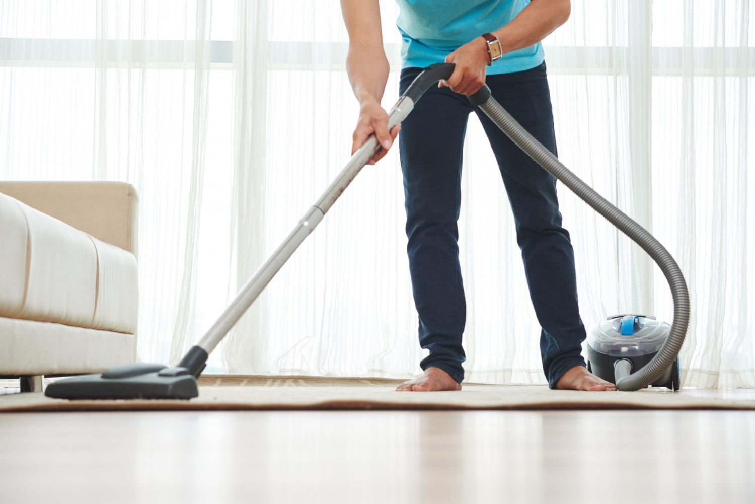 man cleaning area rug