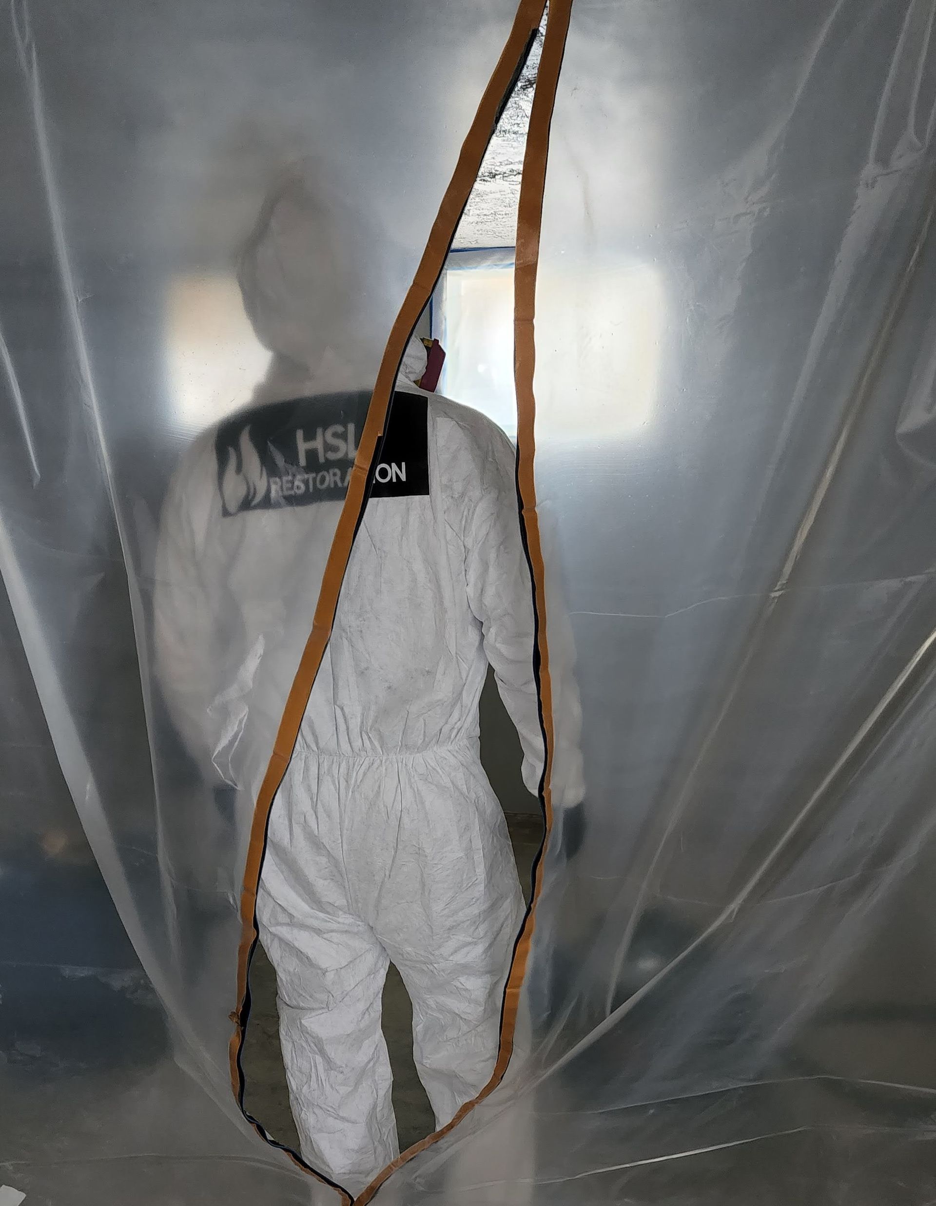 worker going inside to restore home