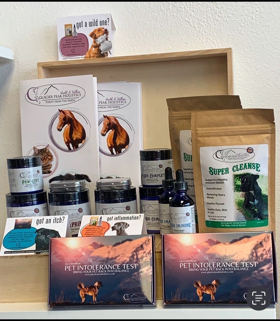 A woman is petting a dog wrapped in a towel