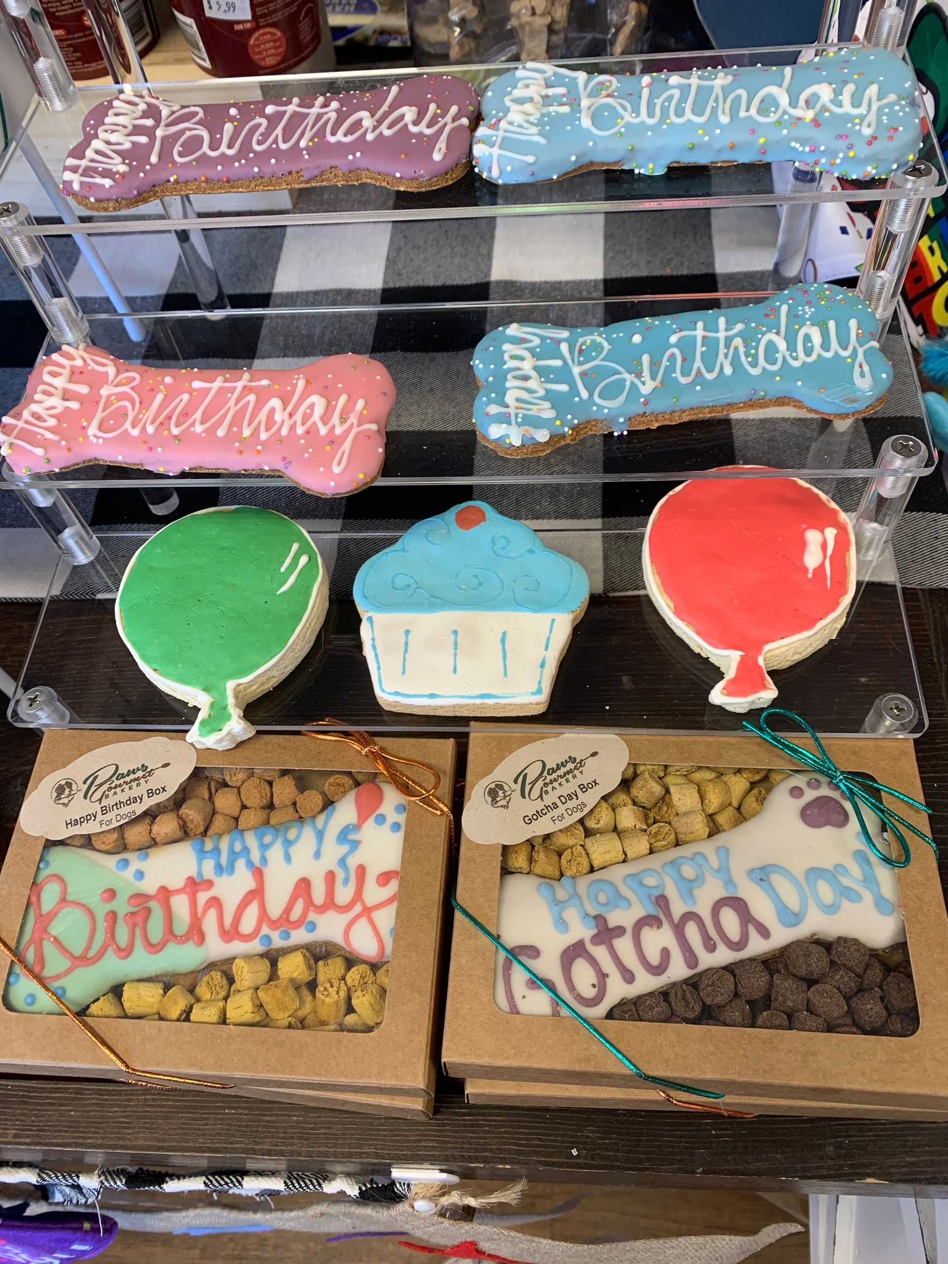 A display of birthday cookies and treats on a table.