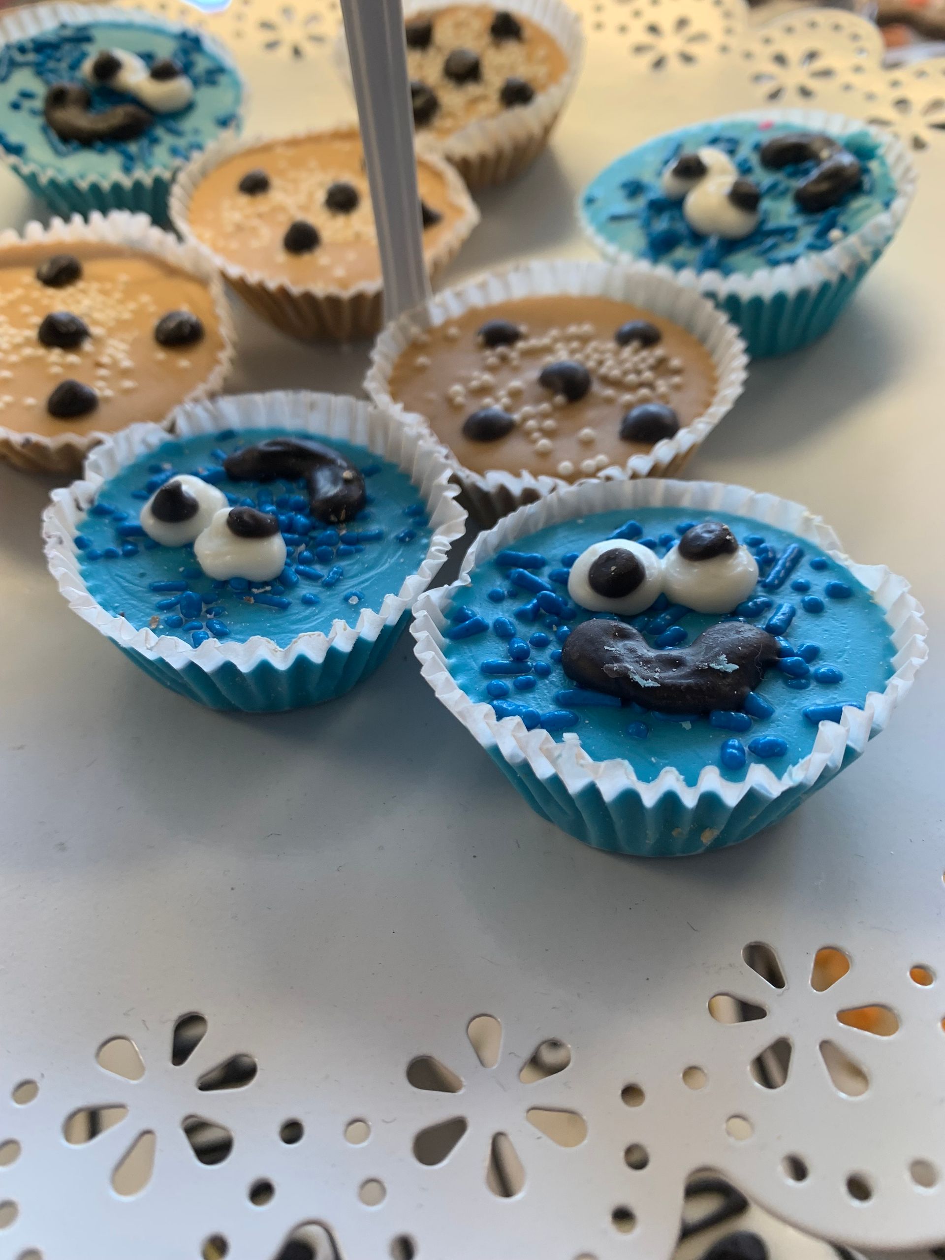 A bunch of cookie monster cupcakes on a table