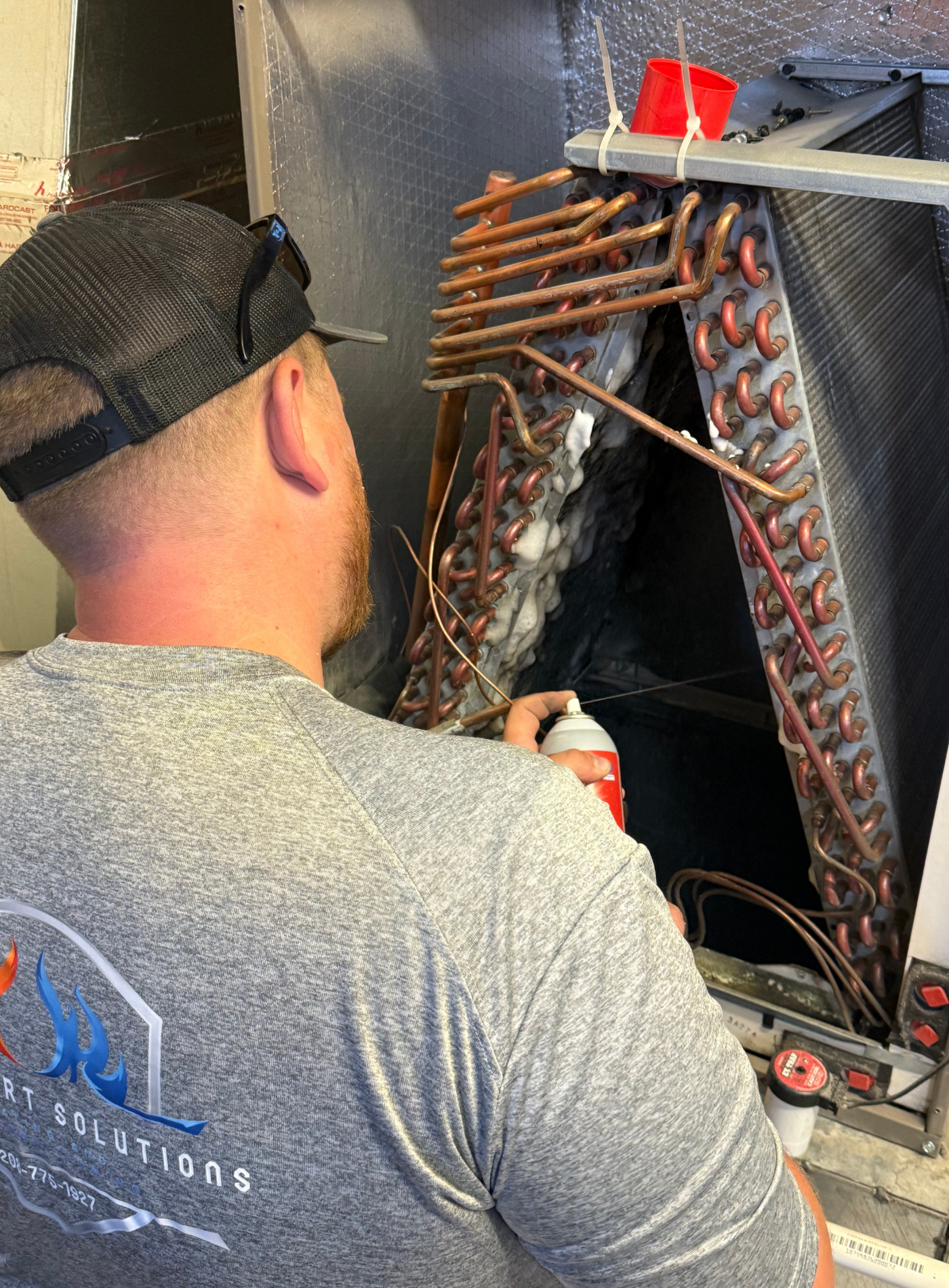 Air conditioning unit near a weathered building. Goodman brand. Auxiliary equipment.