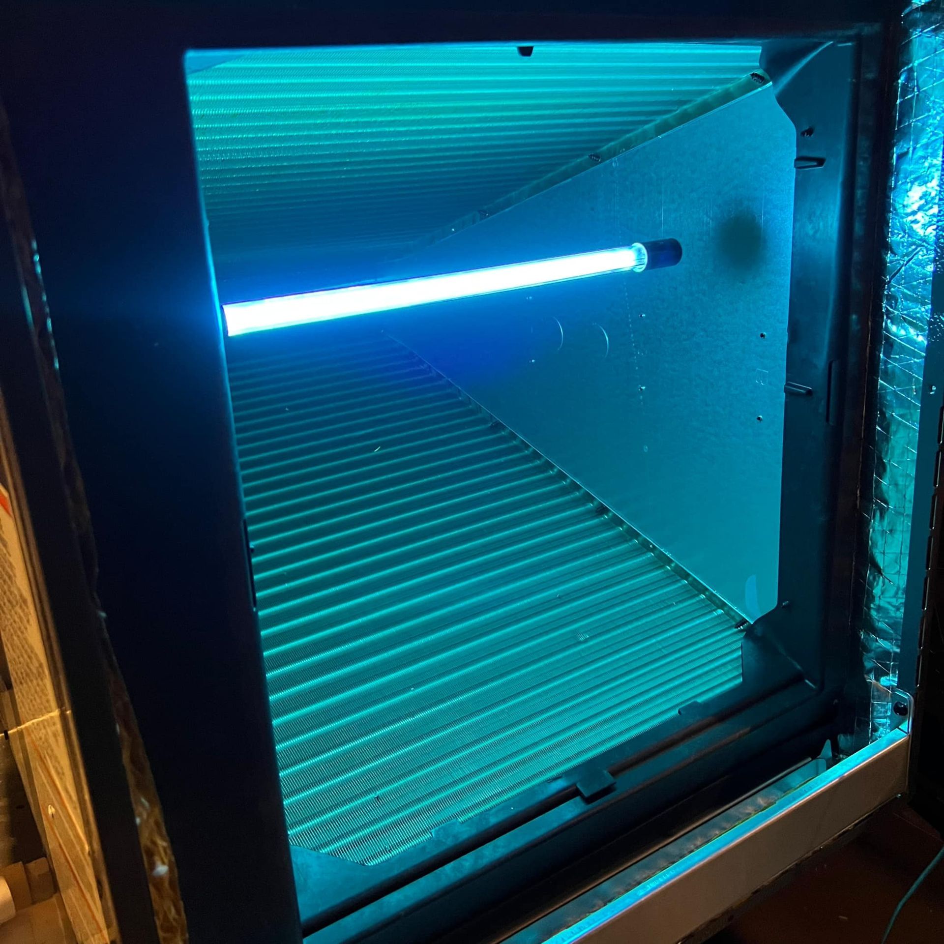 A blue light is shining through a window in a room.
