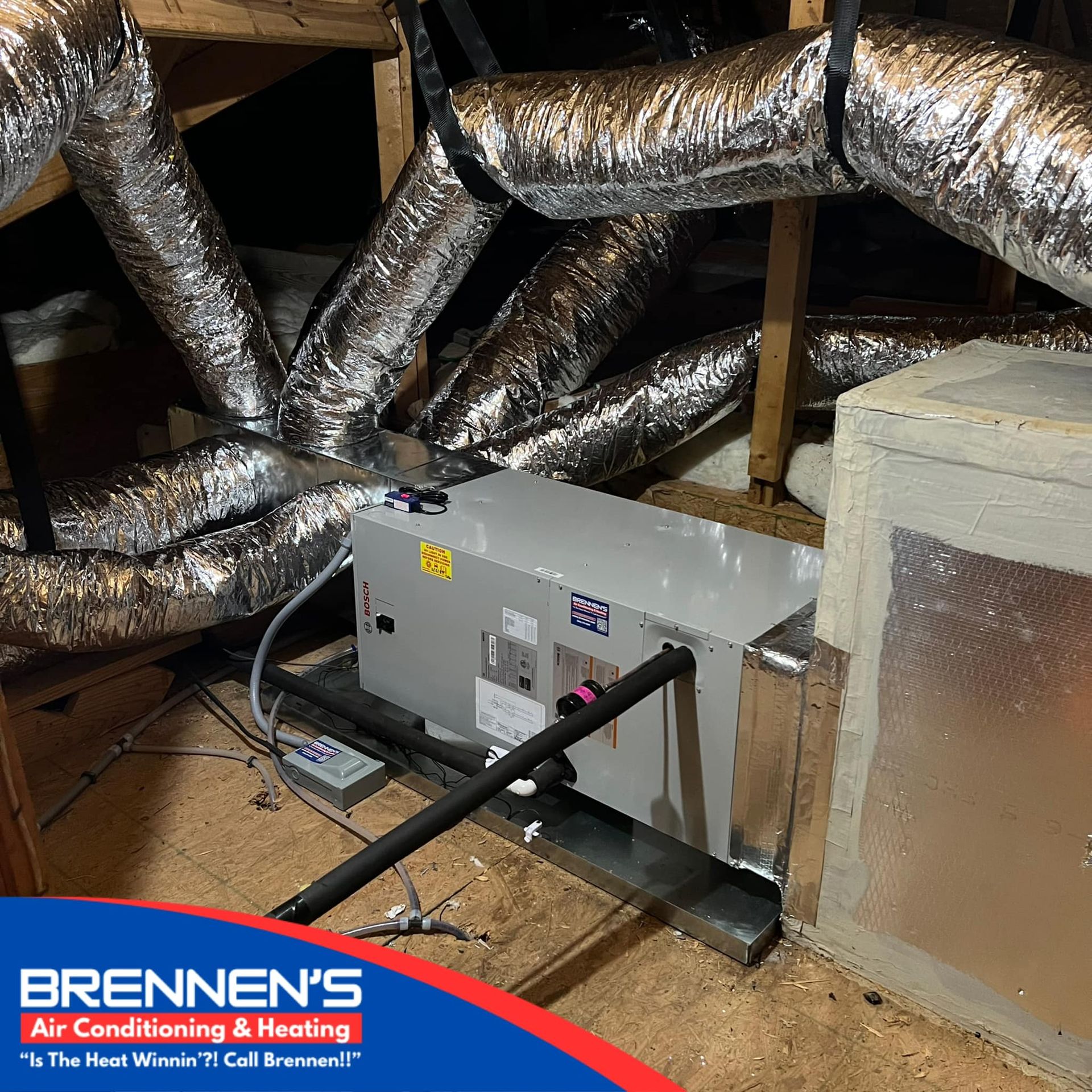 A bunch of ducts are connected to a machine in a room.