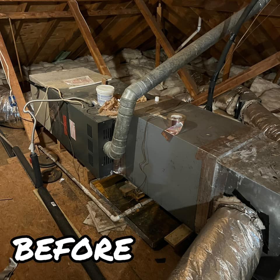 A picture of an air conditioner in an attic before being installed