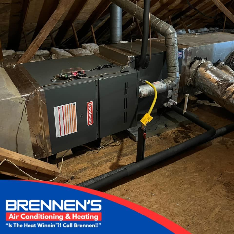 A furnace is sitting in the attic of a house.