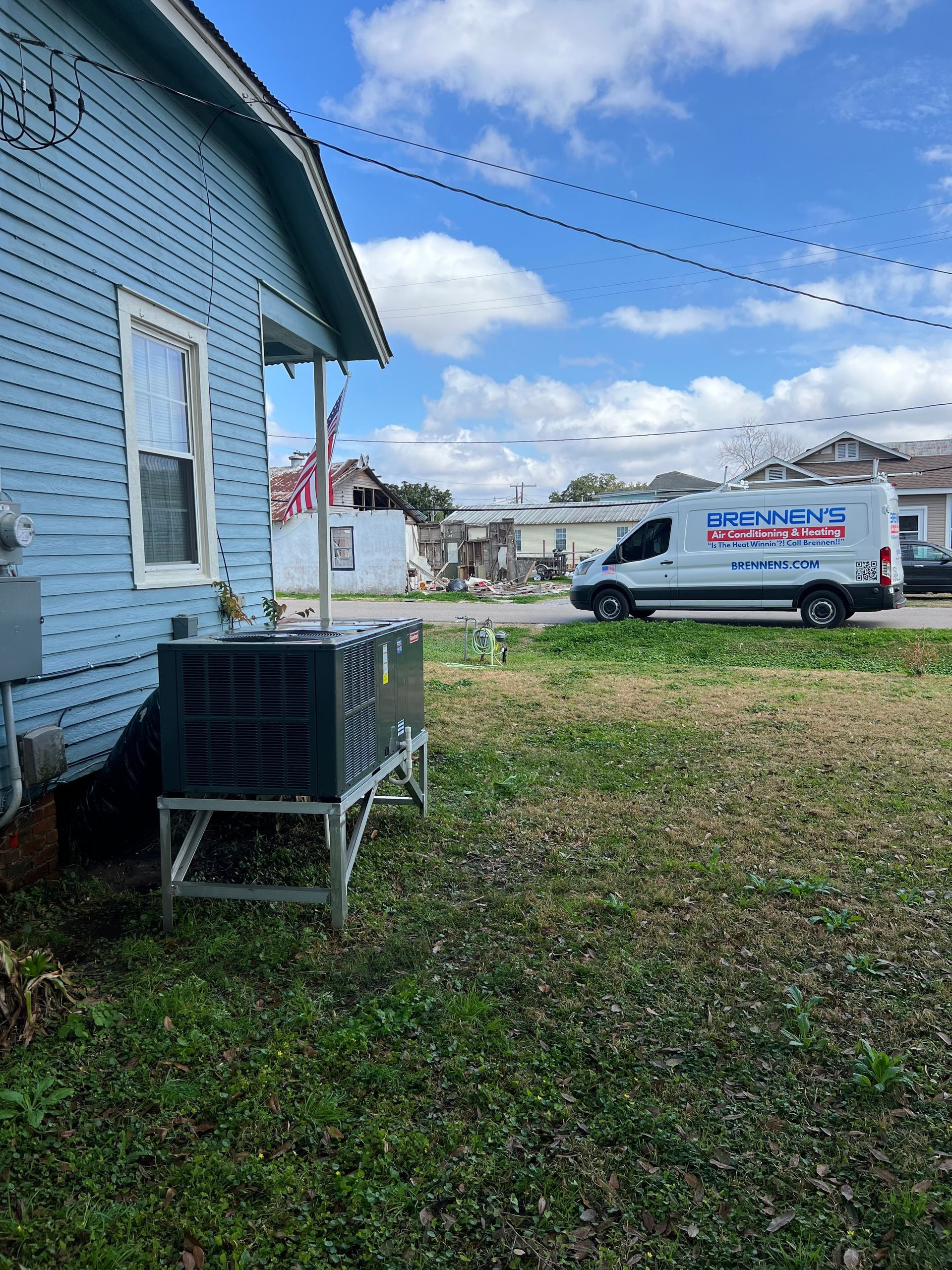 A white van is parked in front of a house.