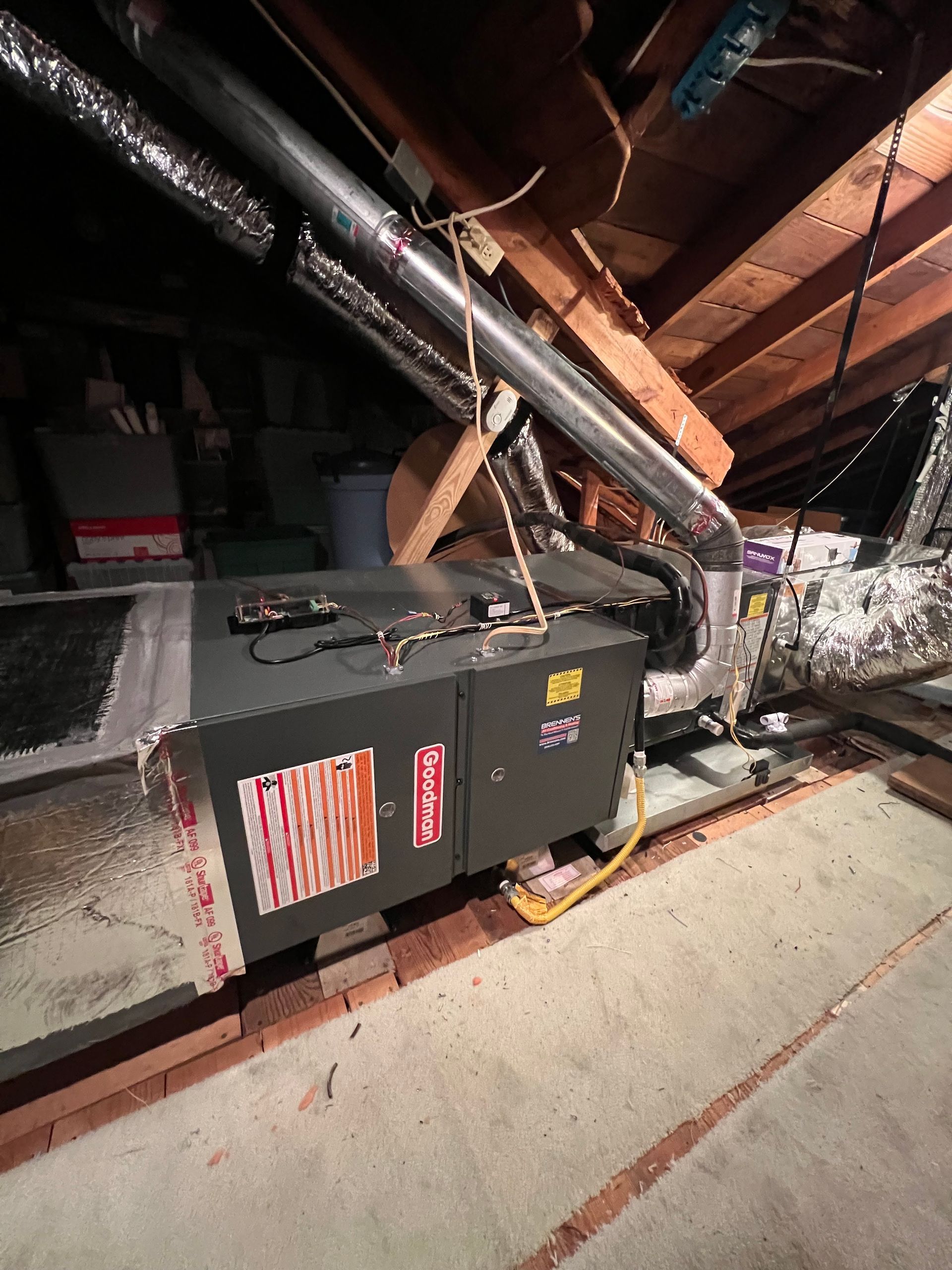 An air conditioner is sitting in the attic of a house.