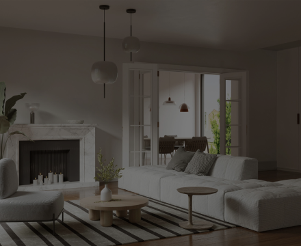 A living room with a couch , chair , coffee table and fireplace.