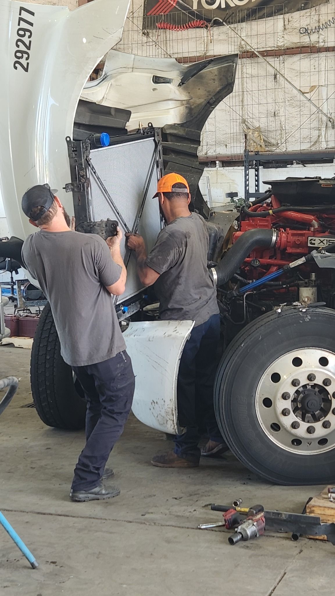 mechanics servicing semi truck
