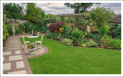 beautiful garden with flowering plants and outdoor seating area
