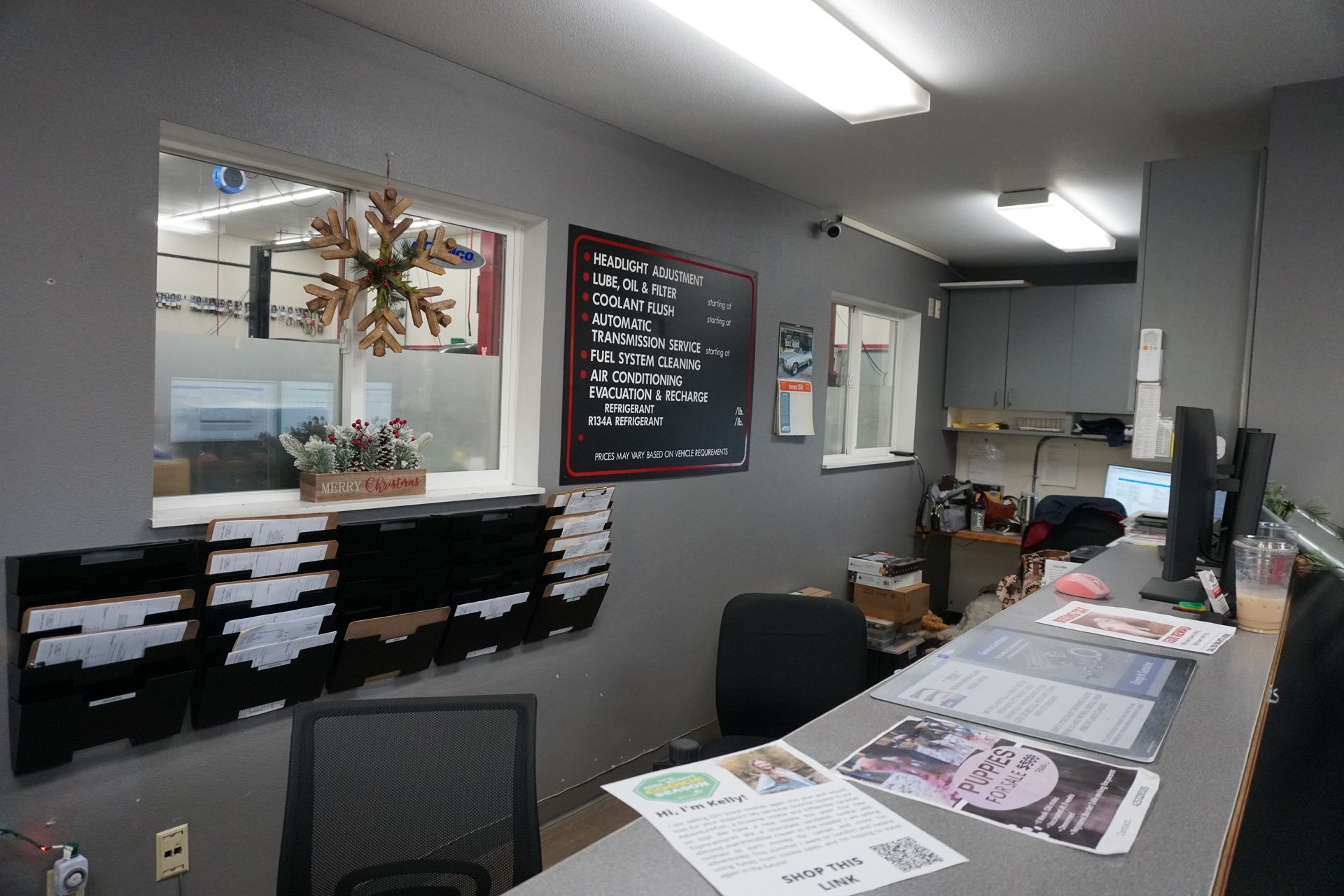 Interior of a small business reception area. Desk with computers, order forms, and chalkboard menu.