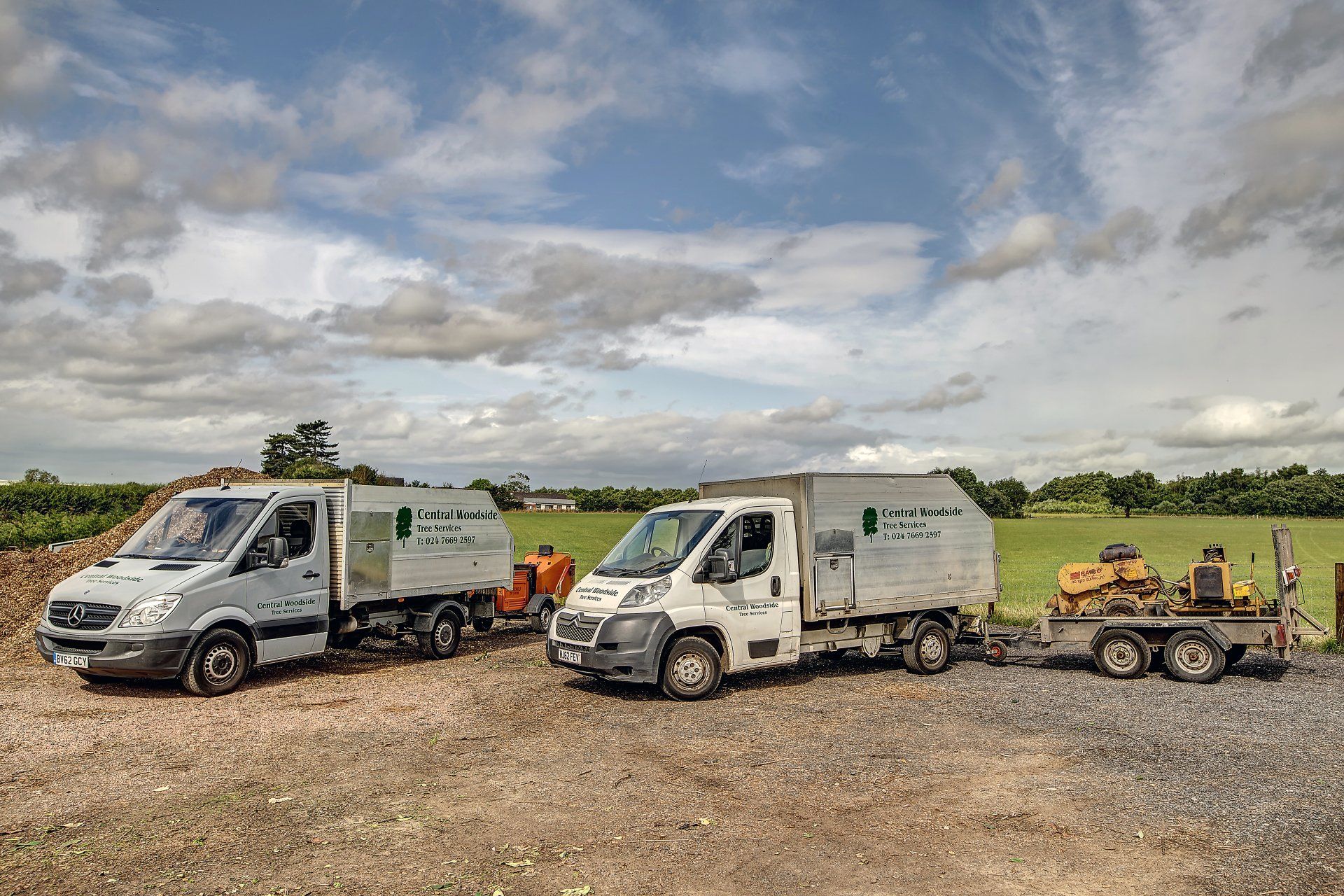 Central Woodside Tree Services work vehicles with a variety of machines