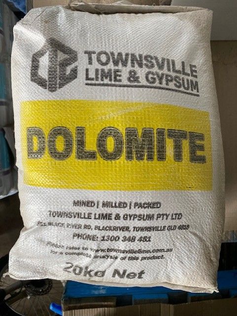 A Bag Of Dolomite Is Sitting On Top Of A Pallet — Edmonds Landscaping Supplies in Bohle Plains, QLD