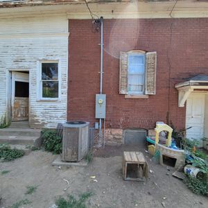 A brick building with a electrical box on the side of it