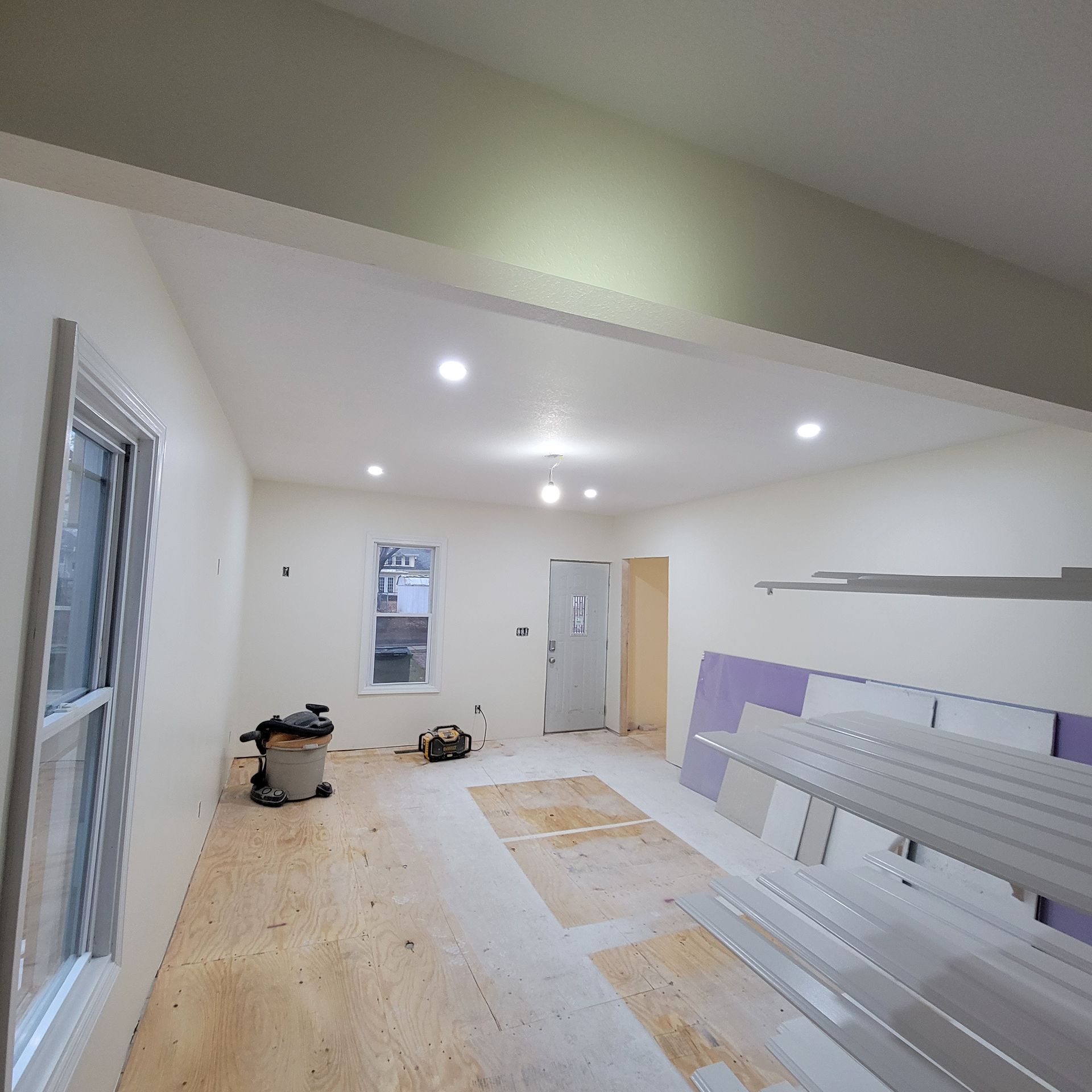 A large room with a vacuum cleaner on the floor