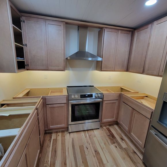 A kitchen with stainless steel appliances and wooden cabinets
