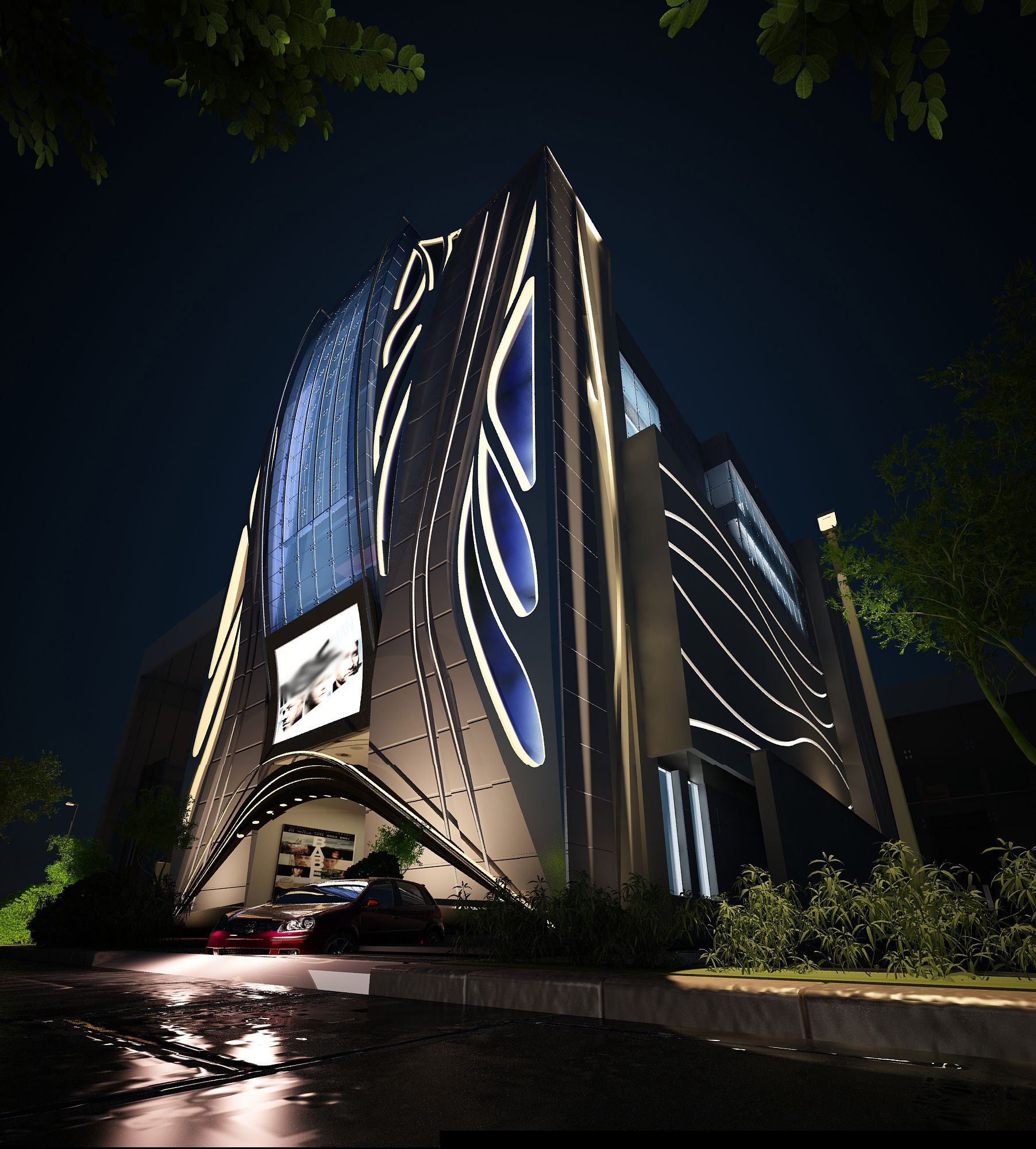 A large building is lit up at night with cars parked in front of it