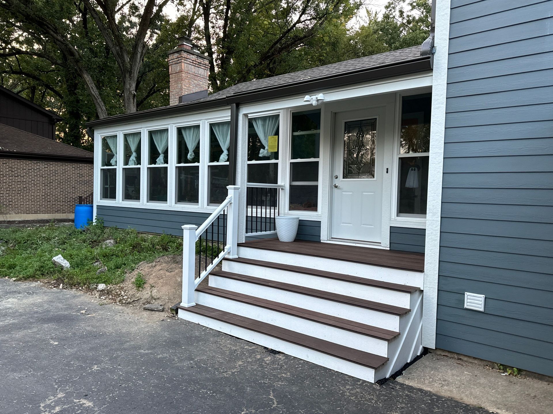 The front of a house with stairs leading up to it.