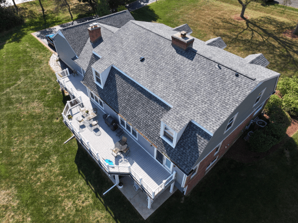 An aerial view of a large house with a gray roof.