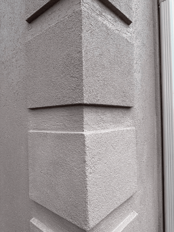 A black and white photo of a corner of a building.