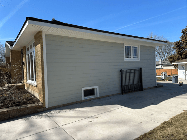 A small house with a fence in front of it