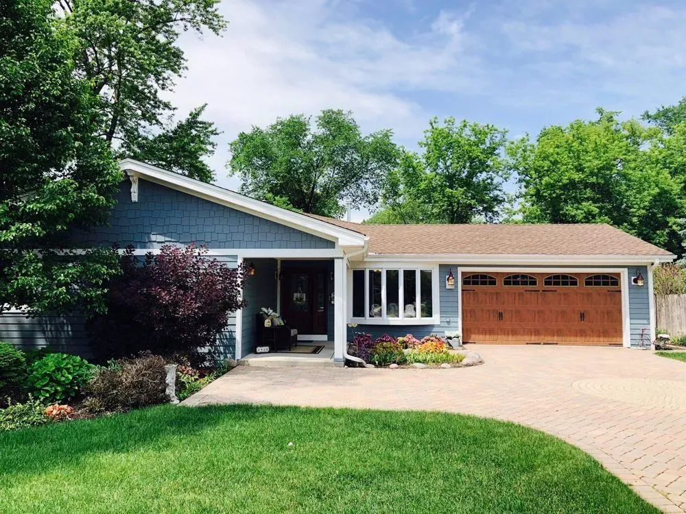 A blue house with a brown garage door