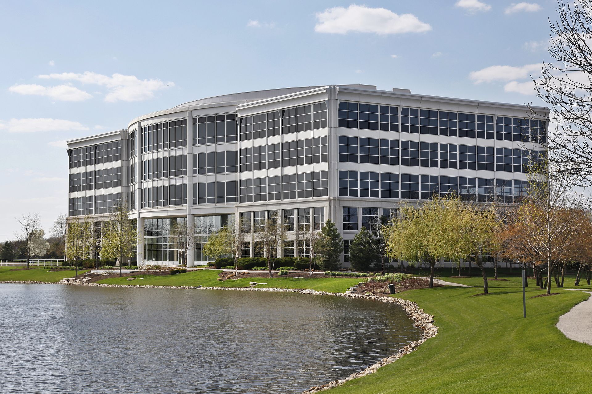 A large building with a lake in front of it